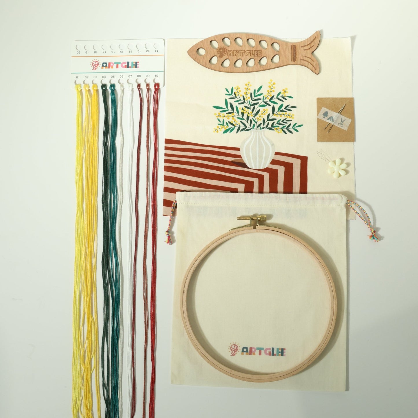 Full acacia embroidery kit contents with printed fabric, threads, fish-shaped thread board, hoop, and cotton bag.