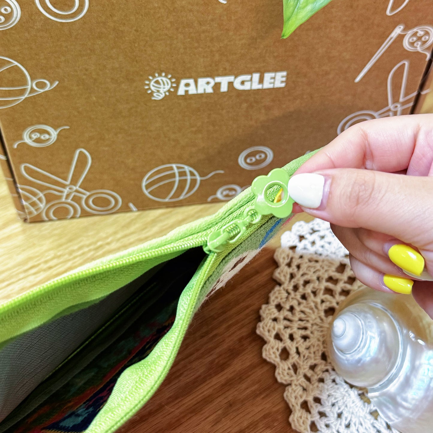 Open view of the Lucky Cats half-stitch zipper pouch showing green lining and roomy interior.