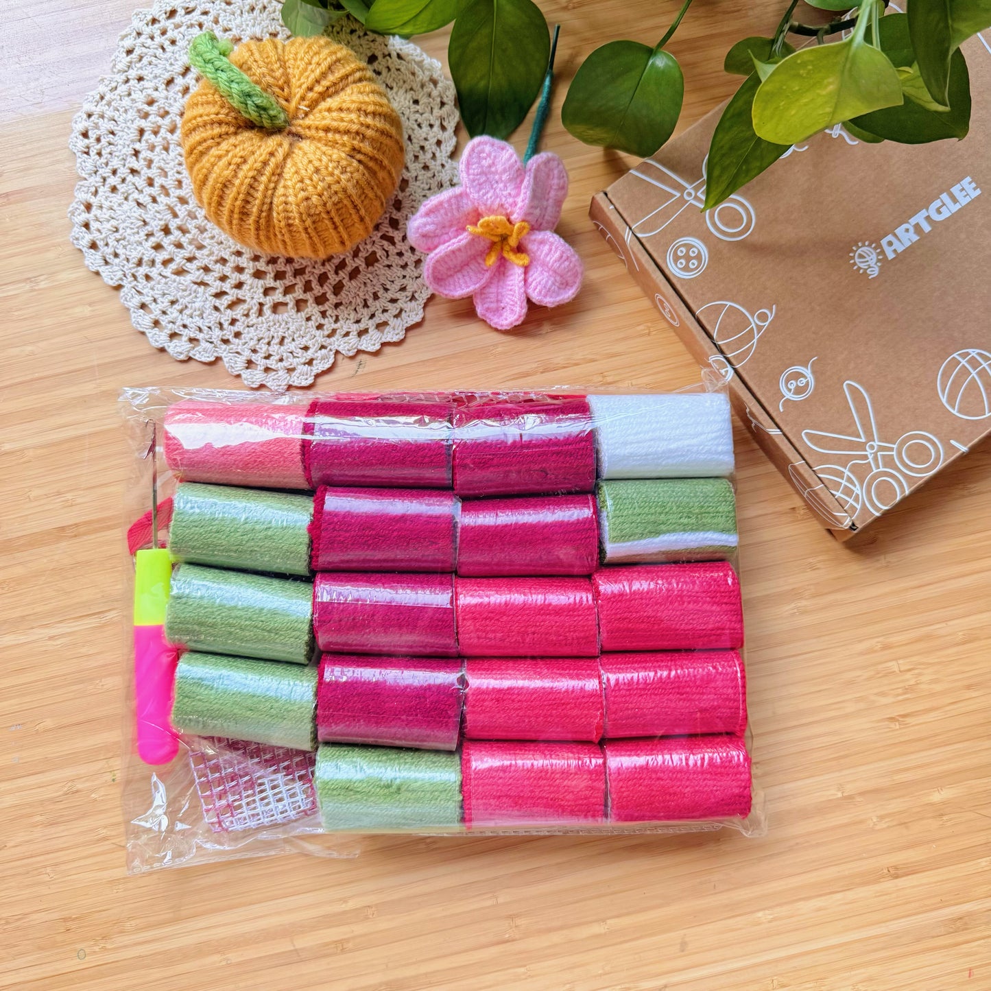 Packaged yarn rolls and latch hook tool included in the Sweet Strawberry latch hook kit