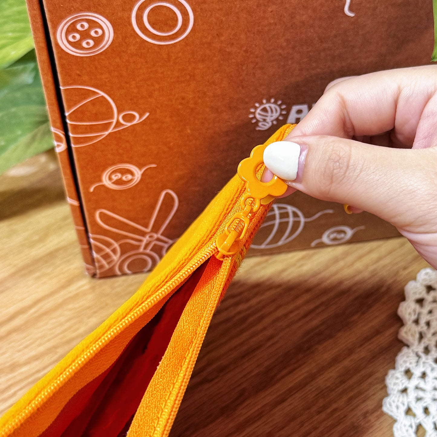 Orange zipper with flower-shaped puller detail on Bloom Daisy Half-Stitch Pouch