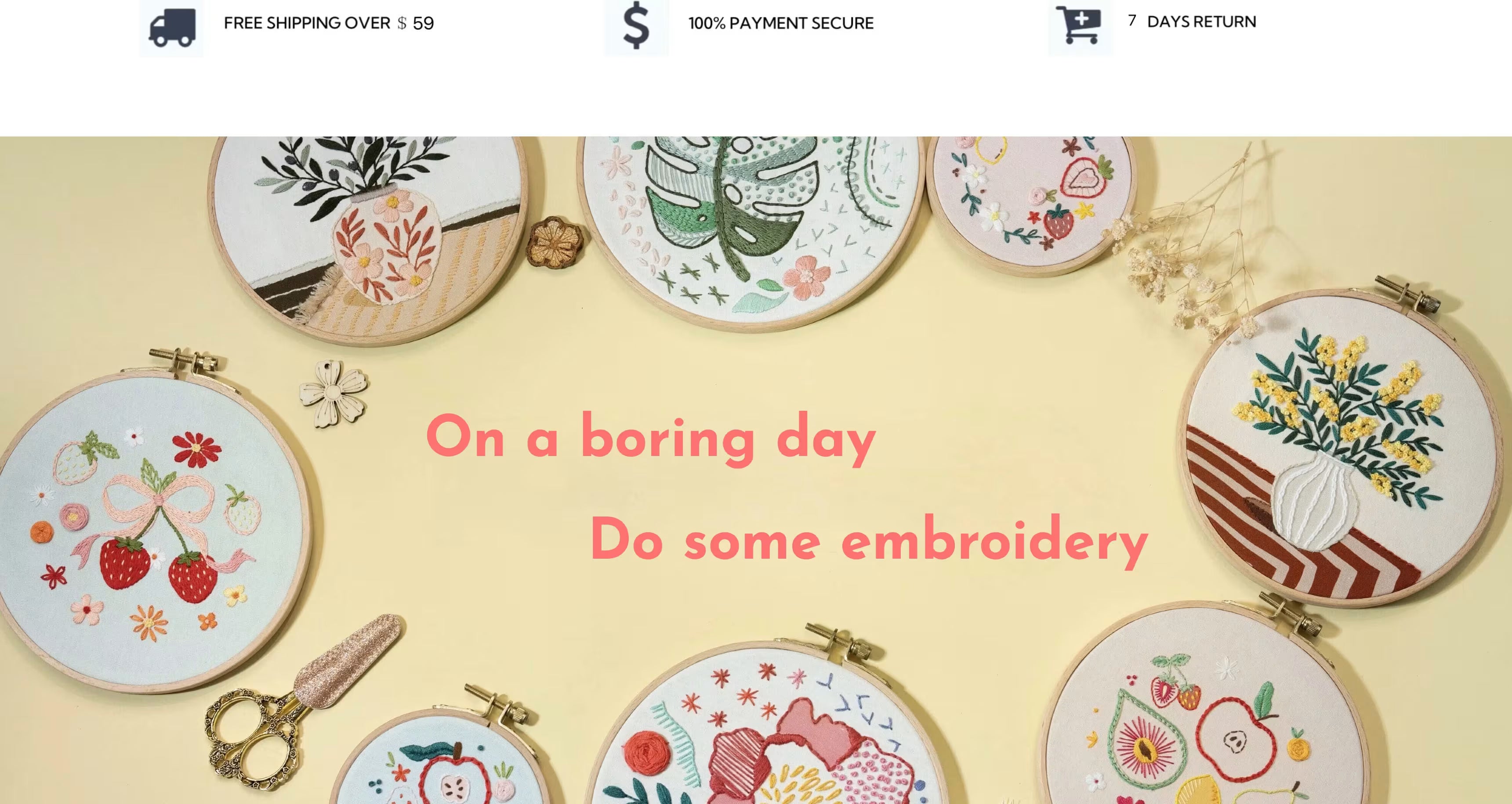 Embroidery kit banner featuring multiple finished embroidery hoop designs arranged around the edges on a soft pastel yellow background, with pink headline text reading “On a boring day / Do some embroidery.” The hoops include floral and botanical patterns, a strawberry-and-bow motif, and a vase with yellow blossoms. Small embroidery accessories and tools (including vintage-style scissors and small decorative pieces) are placed near the hoops, creating a cozy handmade embroidery kit lifestyle scene.
