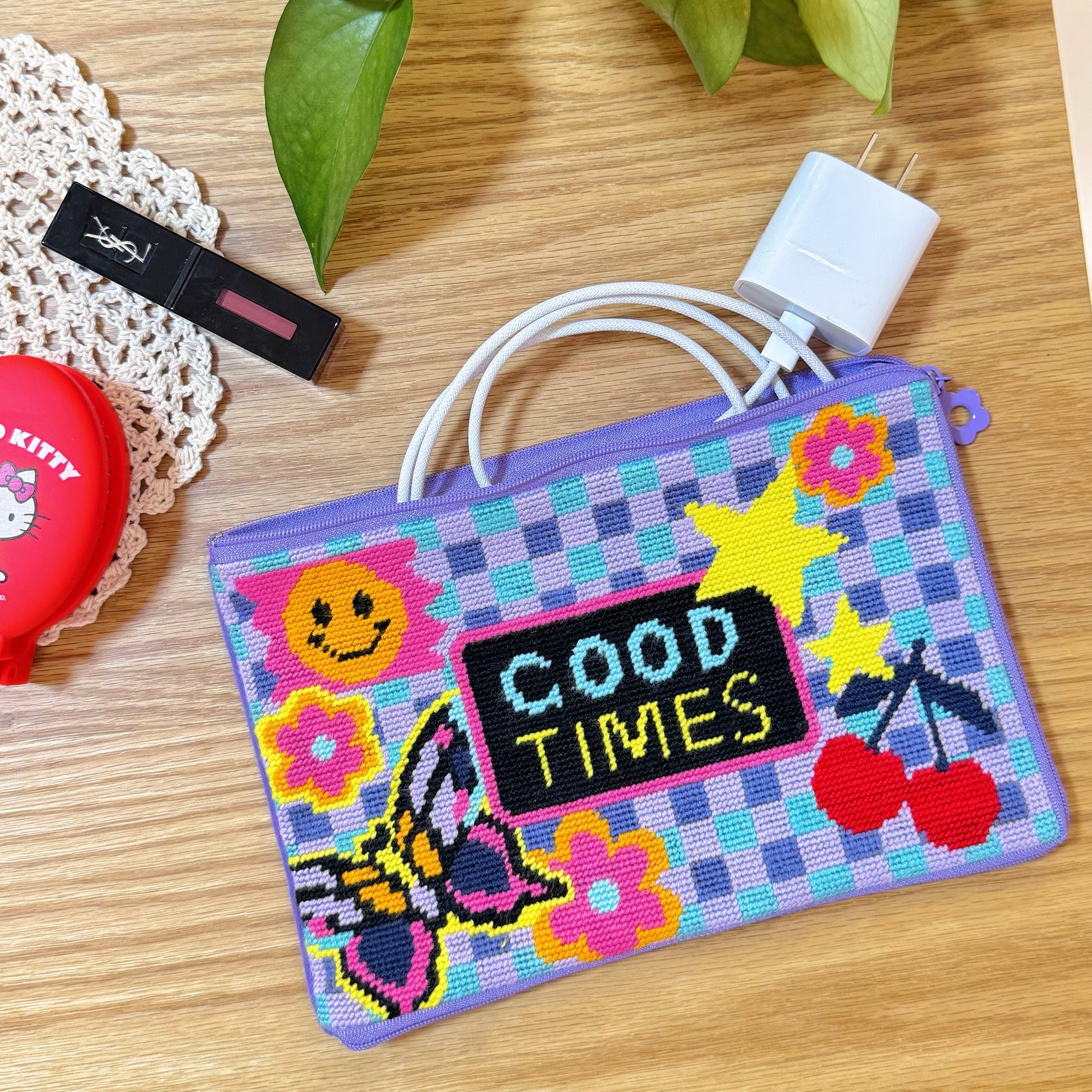 Good Times Half-Stitch Kit pouch styled with makeup and charger accessories, showcasing its practical storage use.
