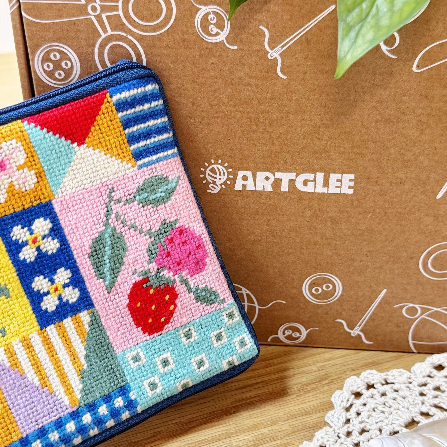Patchwork Garden Half-Stitch Kit pouch displayed with Artglee branded box in background