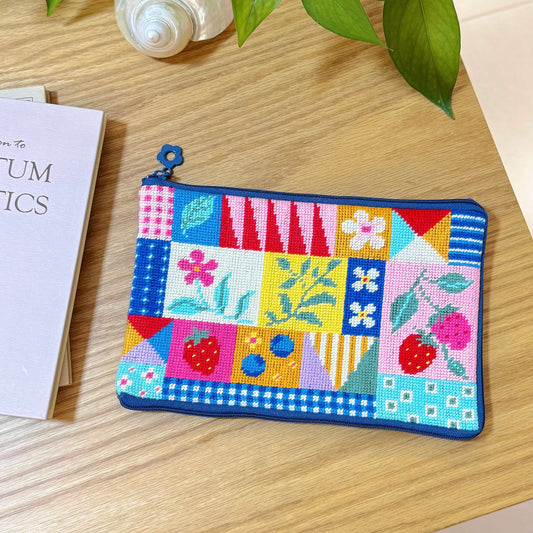 Artglee Patchwork Garden Half-Stitch Kit — colorful patchwork floral pouch flat lay on wooden desk