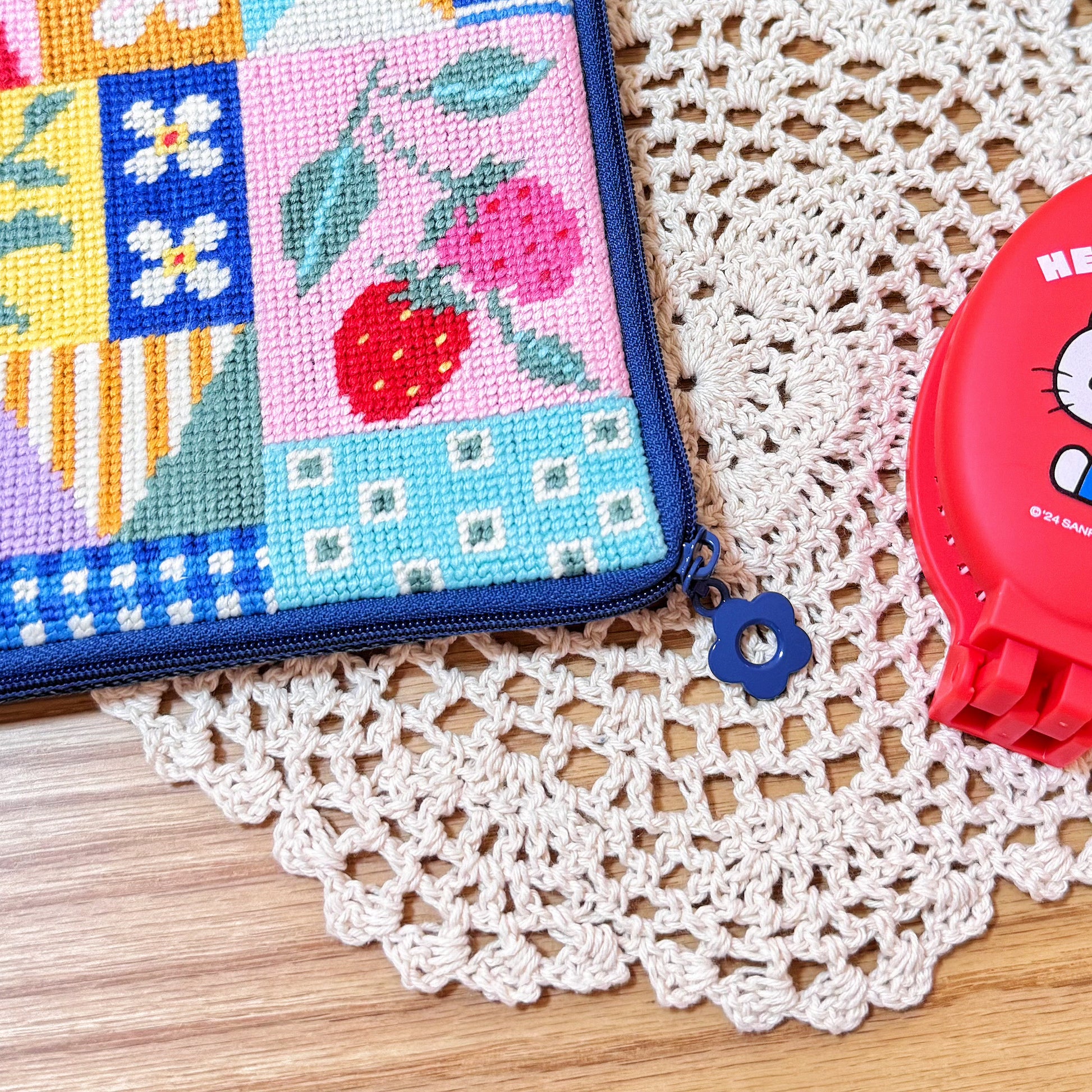 Close-up of blue flower zipper pull on Patchwork Garden Half-Stitch Kit pouch