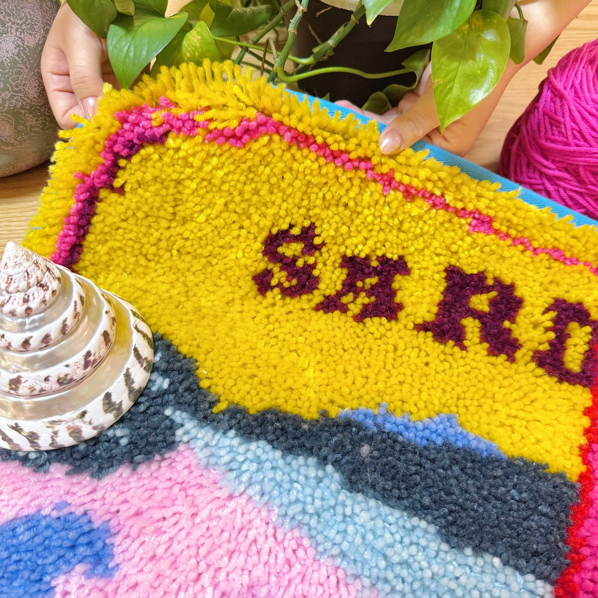 Detailed close-up of yarn texture and sardine lettering on Sardine Delight latch hook rug kit
