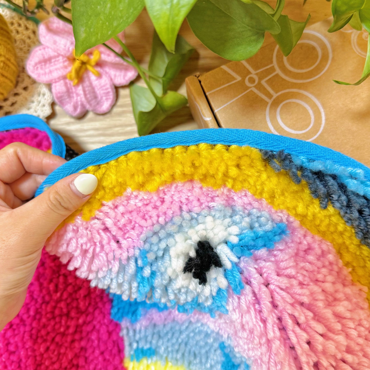 Close-up of finished edge with blue binding on Sardine Delight latch hook rug kit