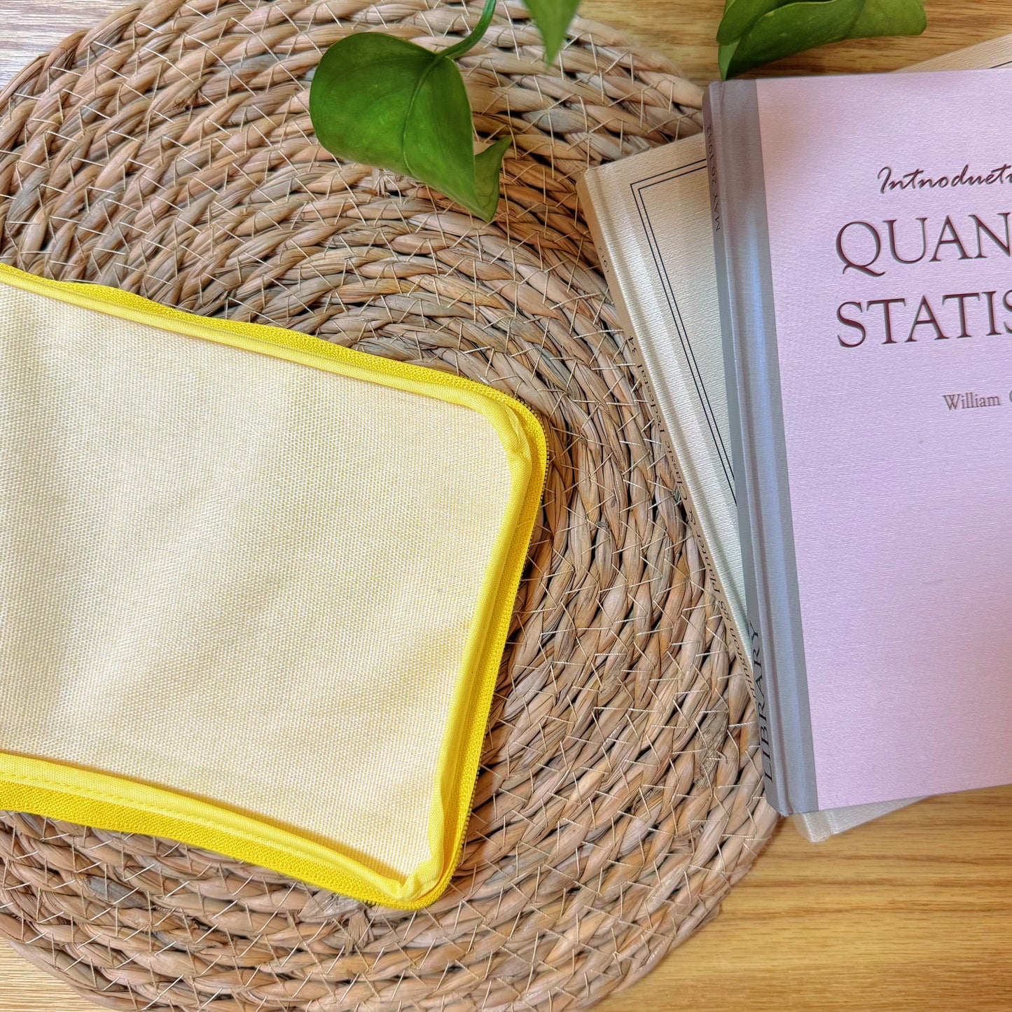 Back view of Sunny Bloom patchwork pouch in plain yellow fabric, displayed on woven mat.